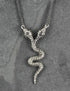 Collier serpent jumeau argenté, entièrement travaillé à la main par Lost Apostle! Vendu chez Tah-dah ! 